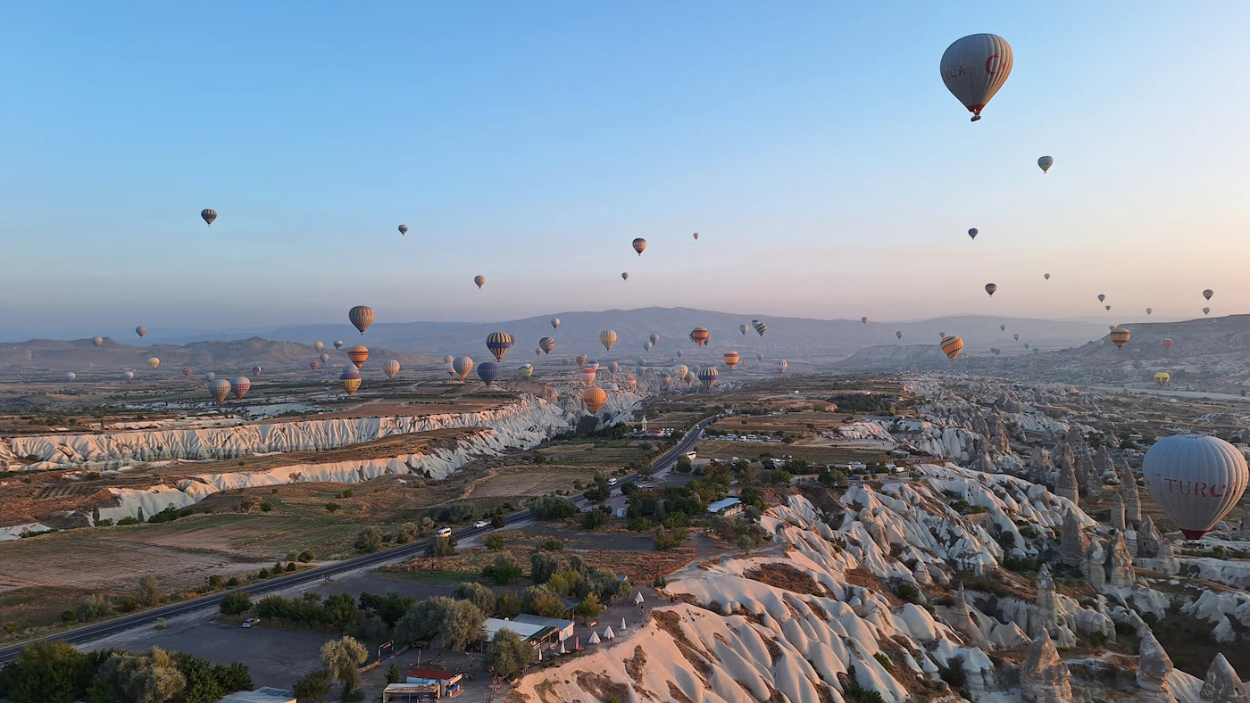 Hot air balloons floating over the rock valleys of Cappadocia