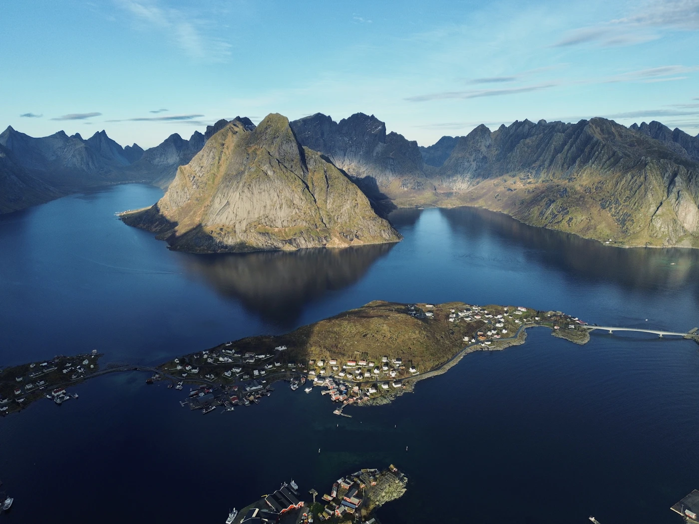 Mountains rising above a deep blue fjord in Lofoten, Norway